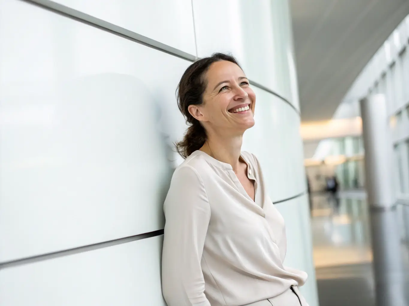 A professional headshot of a diverse woman, Ms. Chloe Davis, in business casual attire, smiling confidently. The background is a co-working space.